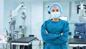 Confident female medical assistant standing in operating room